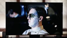 TCL QM581G showing man with sunglasses onscreen